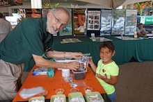 Richard Manshardt shows young girl how to make seed bombs